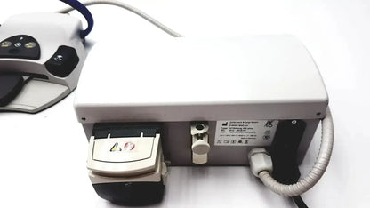 White Kavo Intrasurg 300 dental implant drill with black accents and coiled gray cable for surgical use