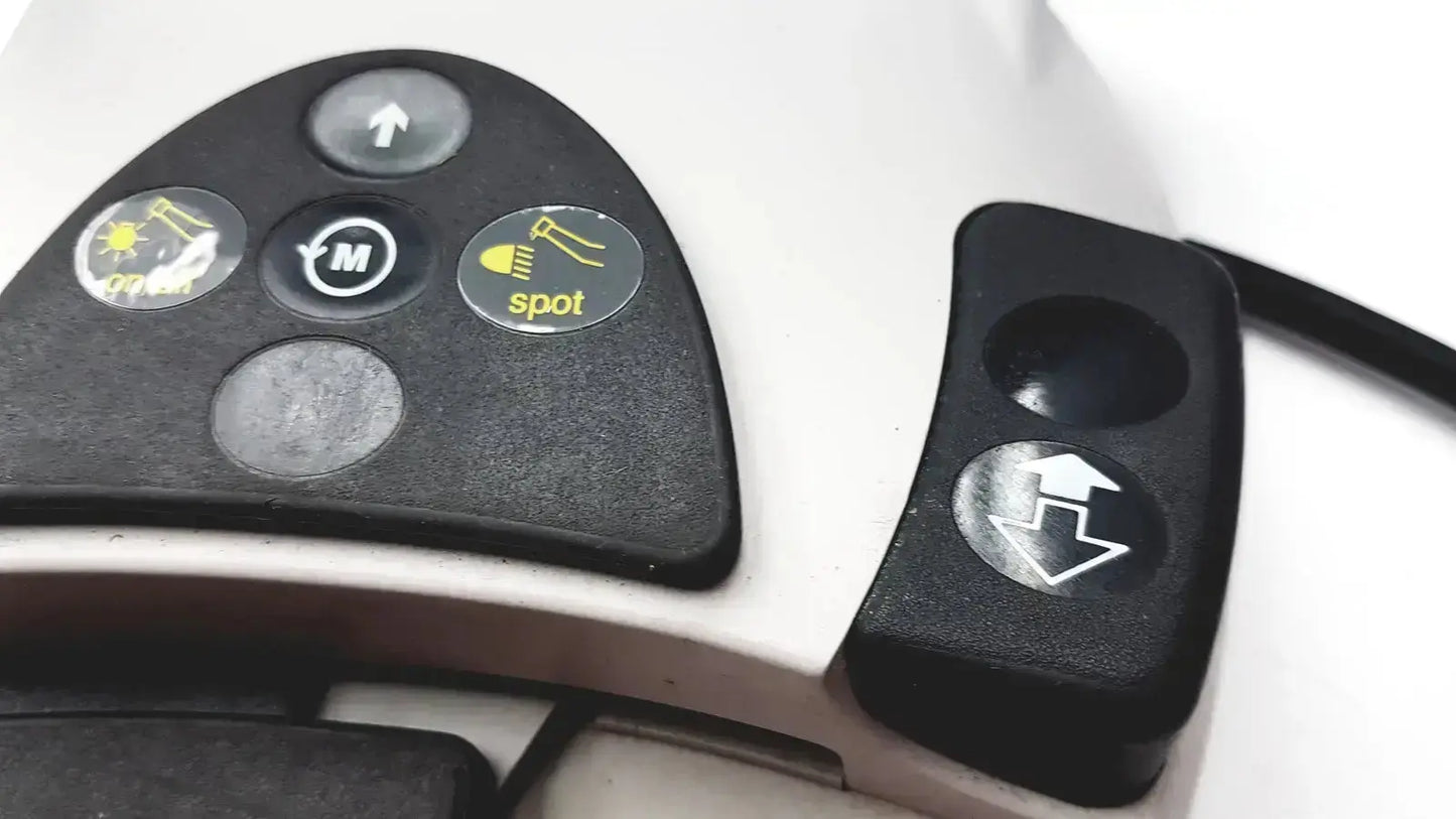 Black control panel with yellow circular buttons on white kavo intrasurg 300 dental implant drill foot control device