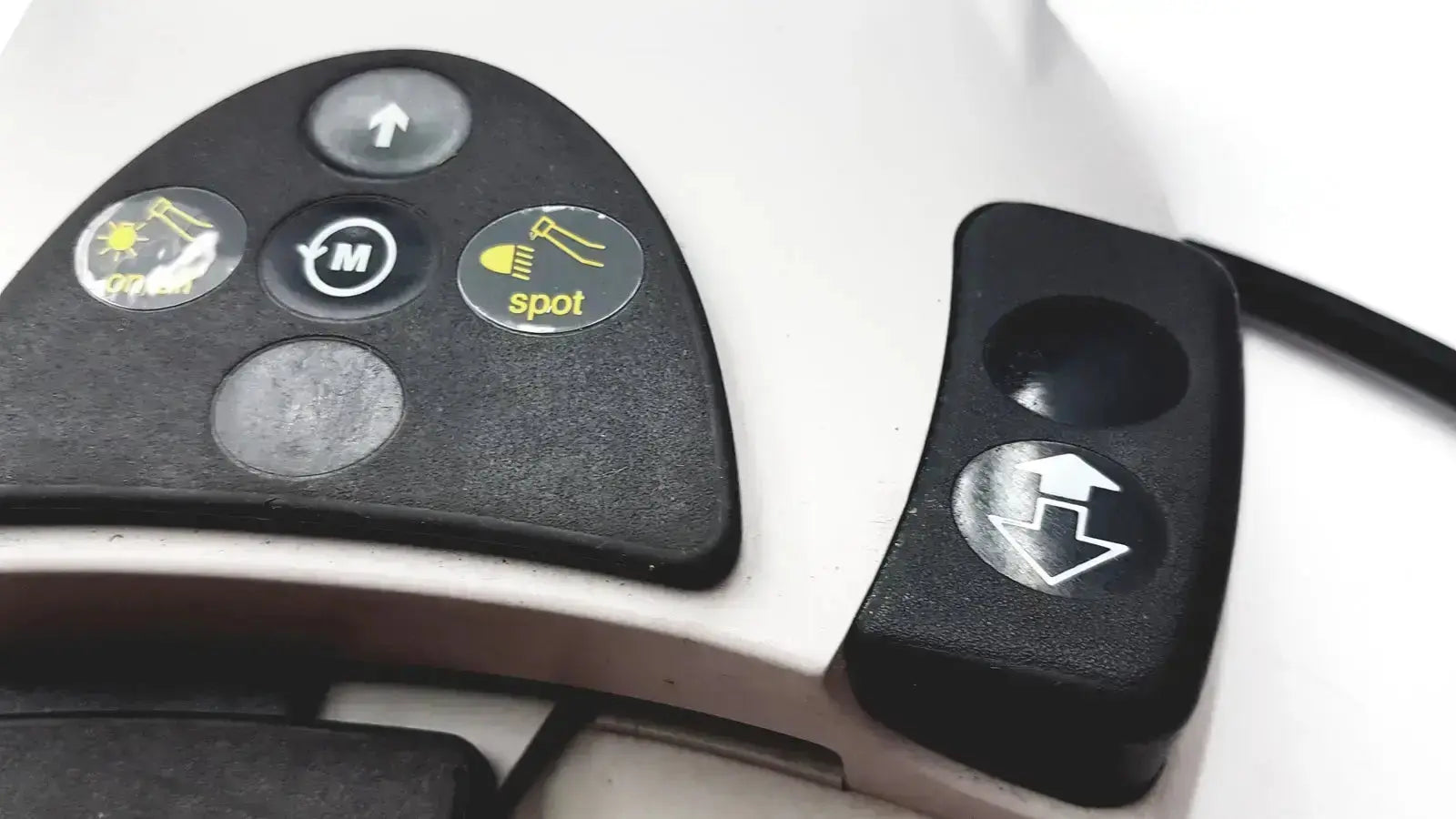 Black control panel with yellow circular buttons on white kavo intrasurg 300 dental implant drill foot control device