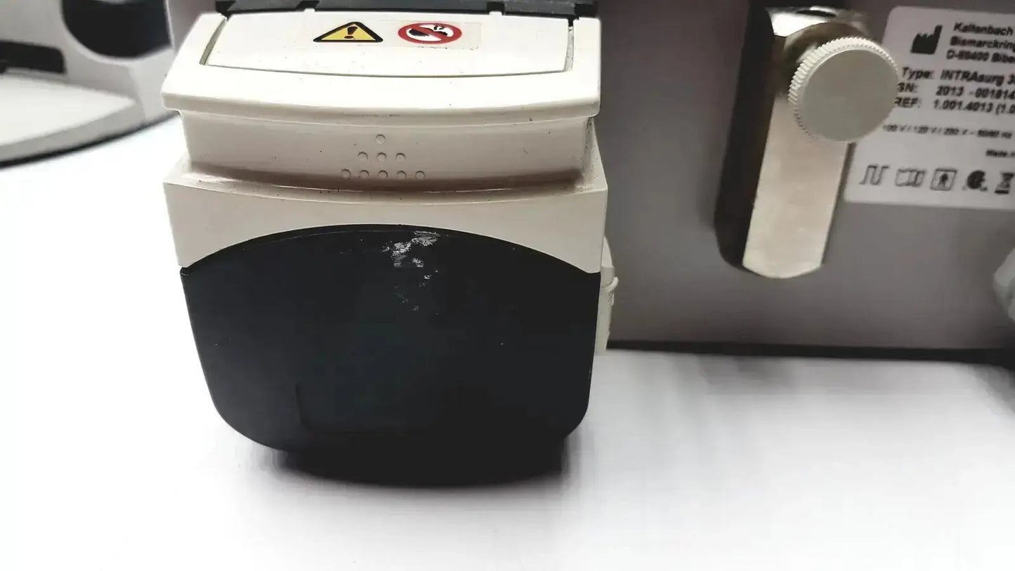 White and black kavo intrasurg 300 dental implant drill system with warning labels for surgical dental implant use
