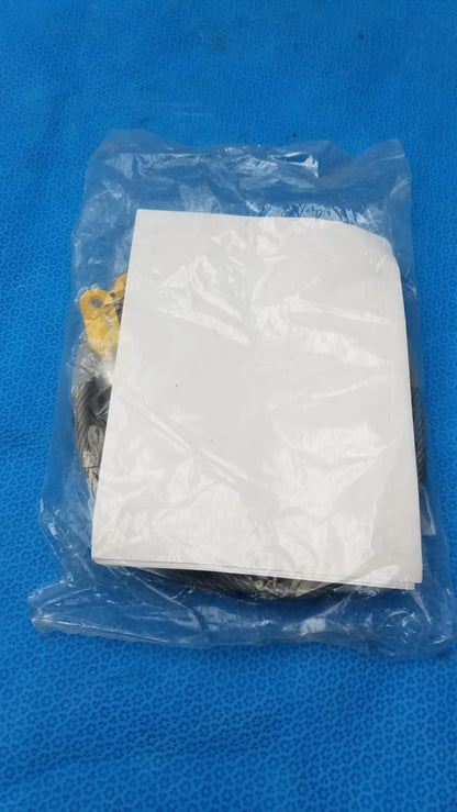 A white paper insert inside a clear plastic bag partially obscures yellow and metallic parts of the kensington locking kit for pre owned medical equipment use