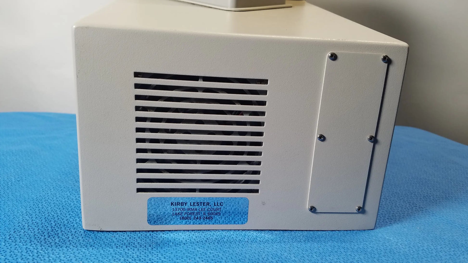 Beige rectangular kirby lester kl15e pharmacy tablet and capsule counter with vented side panel and blue brand label