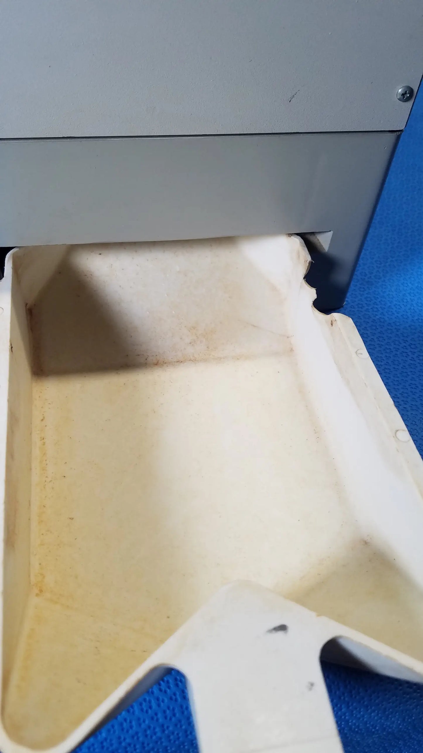 White plastic tray with molded edges and discoloration used in kirby lester kl15e medical equipment for pharmacy counting