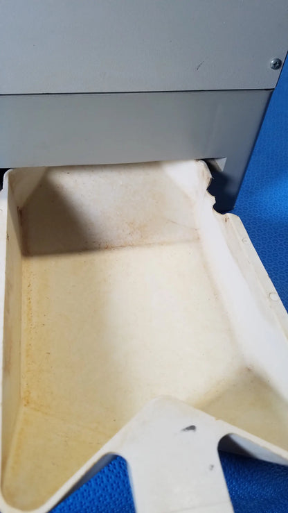 White plastic tray with molded edges and discoloration used in kirby lester kl15e medical equipment for pharmacy counting