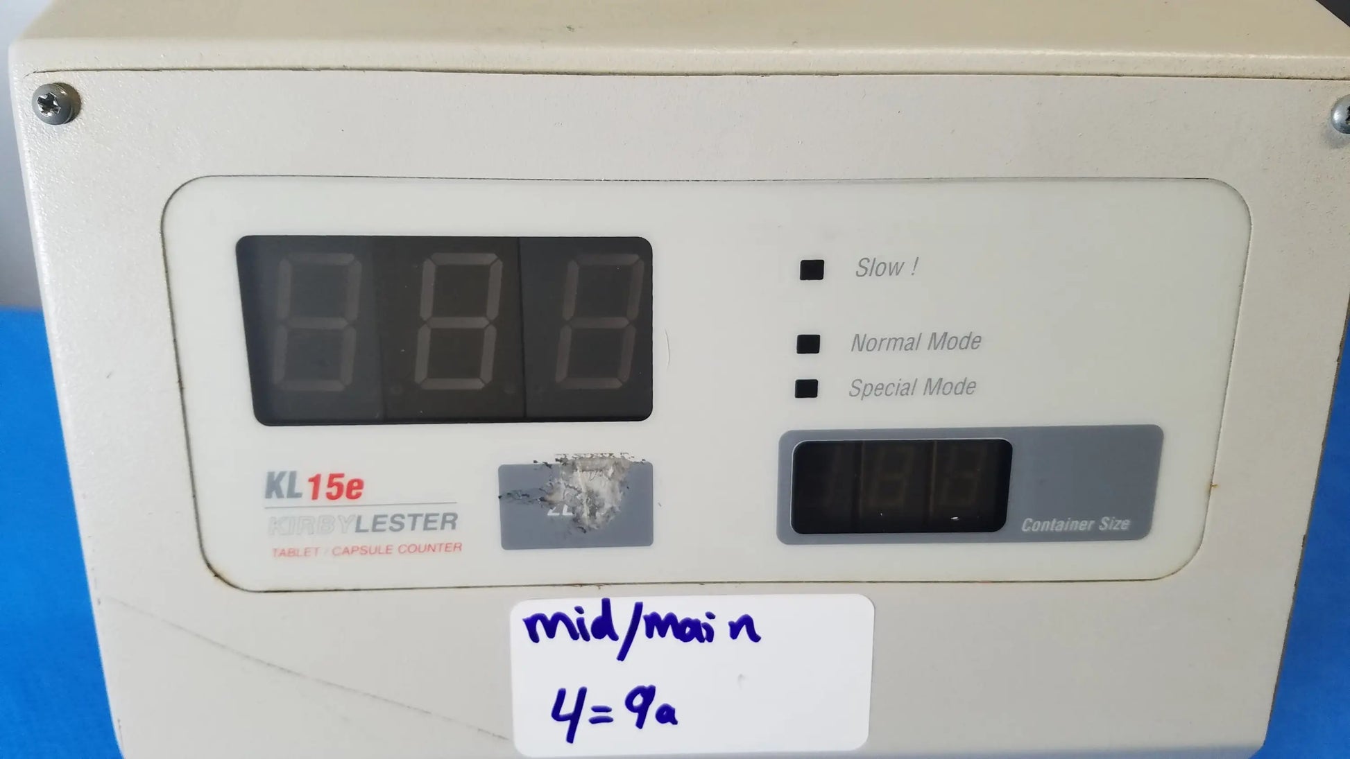 White plastic kirby lester kl15e pharmacy tablet and capsule counter with digital display and labeled mode buttons for medical equipment use
