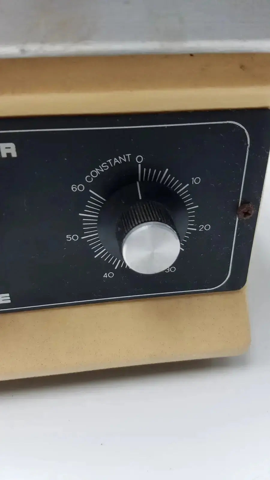 Black control panel with silver rotary dial on wooden base of lab-line orbit mixer shaker model 3520