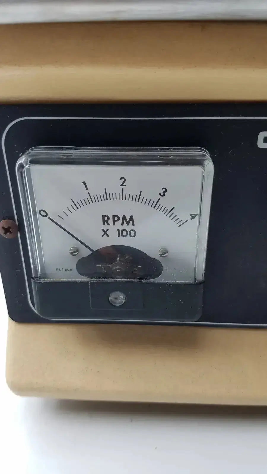 Black analog rpm meter with white dial and clear cover on lab-line orbit mixer shaker model 3520 orbit mixer shaker
