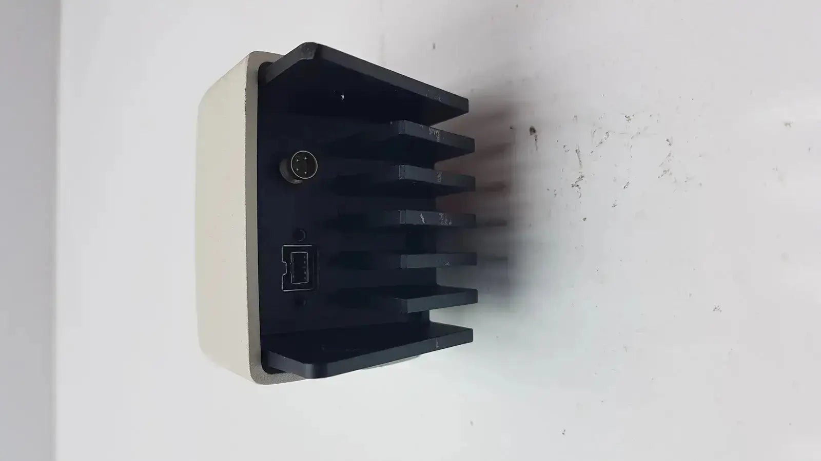 Black and beige plastic heat sink with circular connector and usb interface on the back of leica dfc450 5mp microscope camera