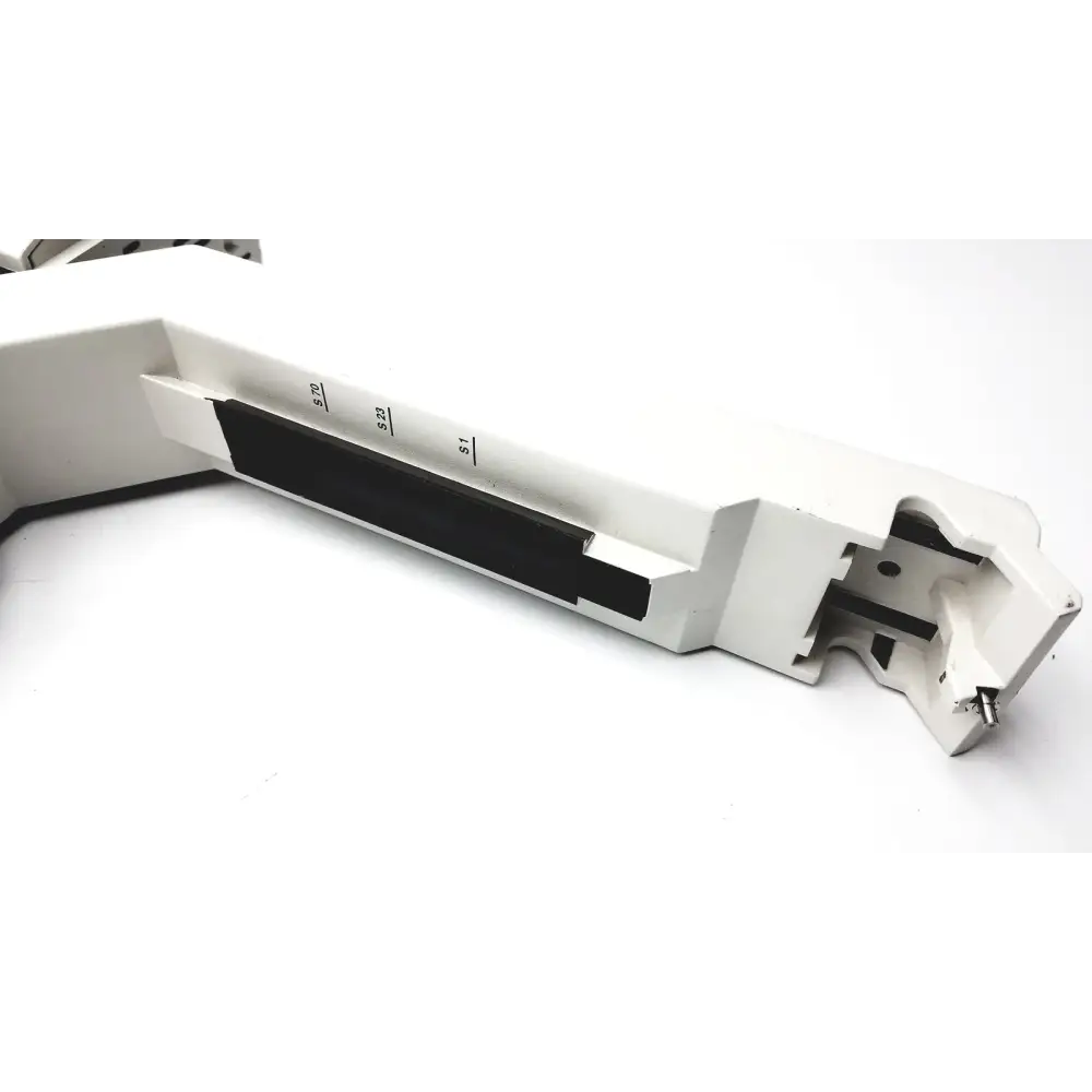 White metal lathe tool holder with black insert and engraved measurement markings.