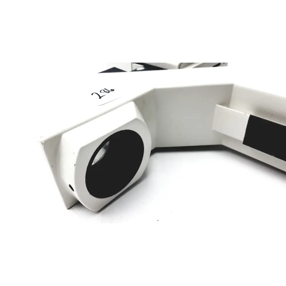 White plastic microscope stage with black circular aperture and a rectangular slot on the side.