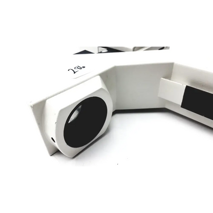 White plastic microscope stage with black circular aperture and a rectangular slot on the side.