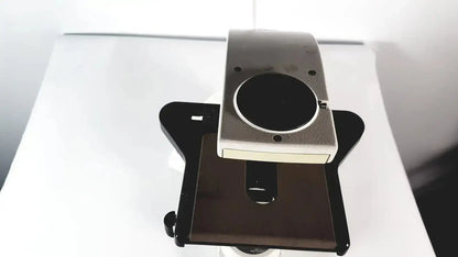 Silver and black digital camera mount with circular lens opening for leica dm1000 led microscope microsystems base