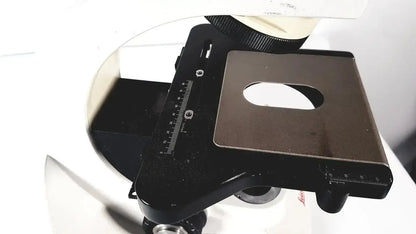 Black metal microscope stage with central oval cutout and measurement scales for leica dm1000 led microscope base