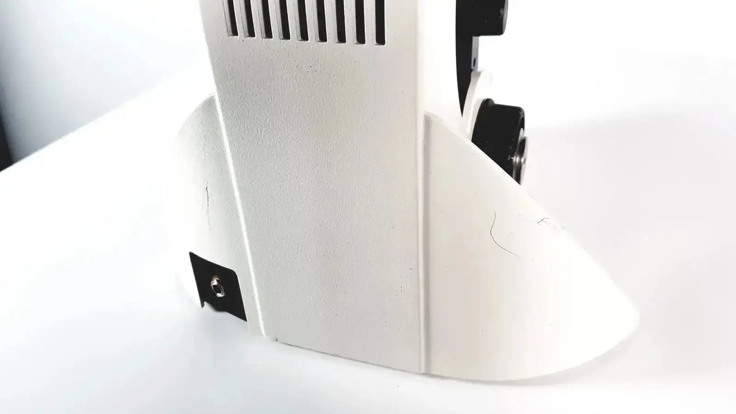 White plastic base of leica dm1000 led microscope with black ventilation slits and adjustment knobs for microsystems use