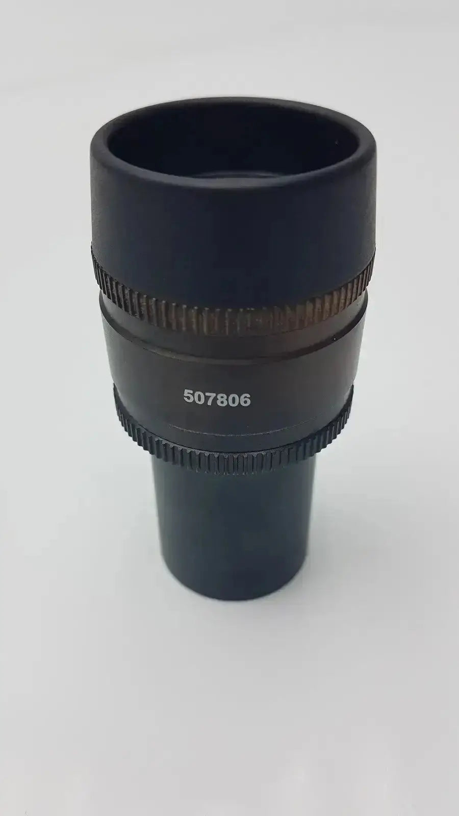 Black cylindrical leica hc plan microscope eyepiece with textured focus rings and engraved serial number 507806 hospital surplus