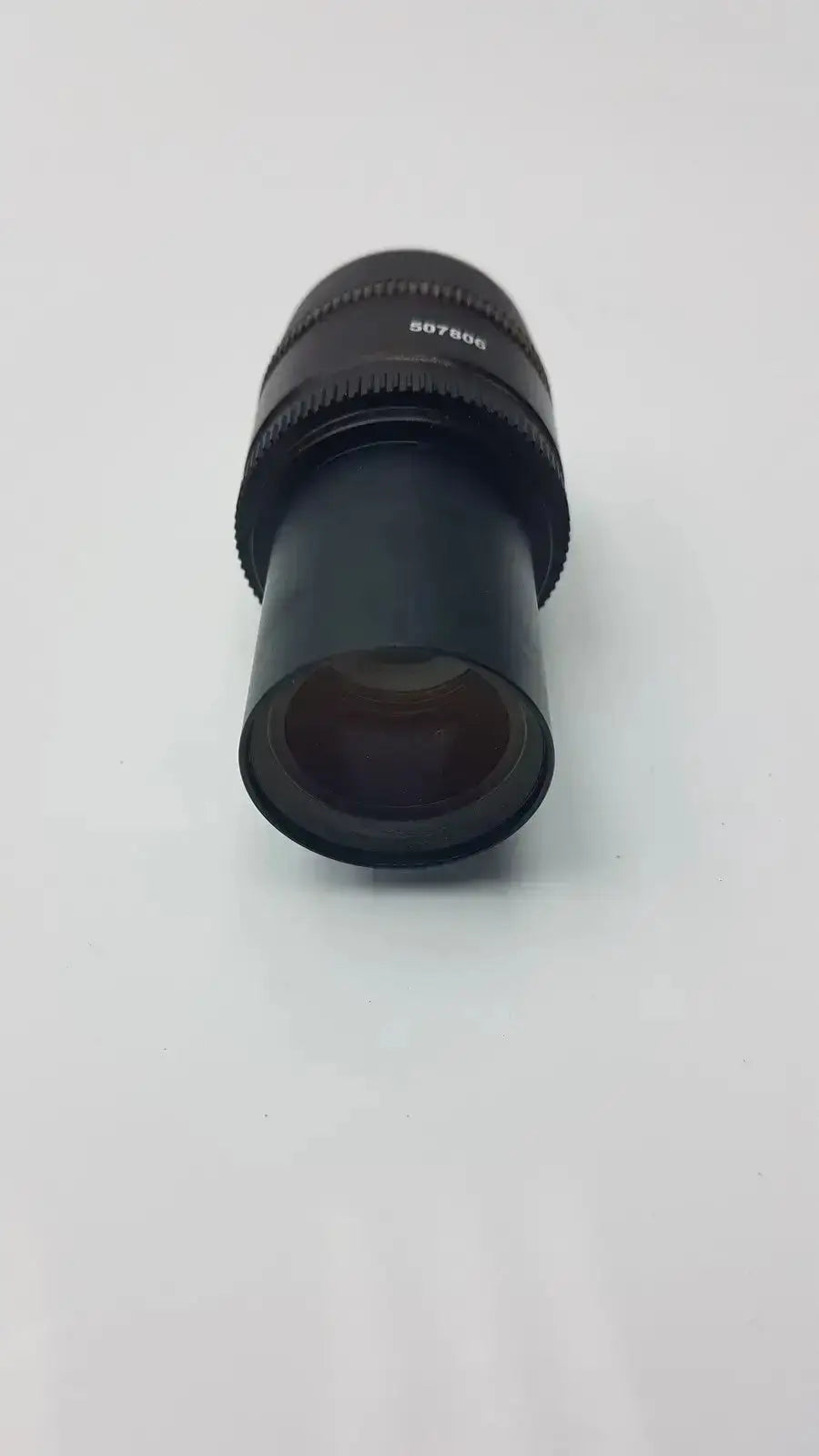 Black cylindrical leica hc plan microscope eyepiece with textured focus ring and engraved serial number from hospital surplus