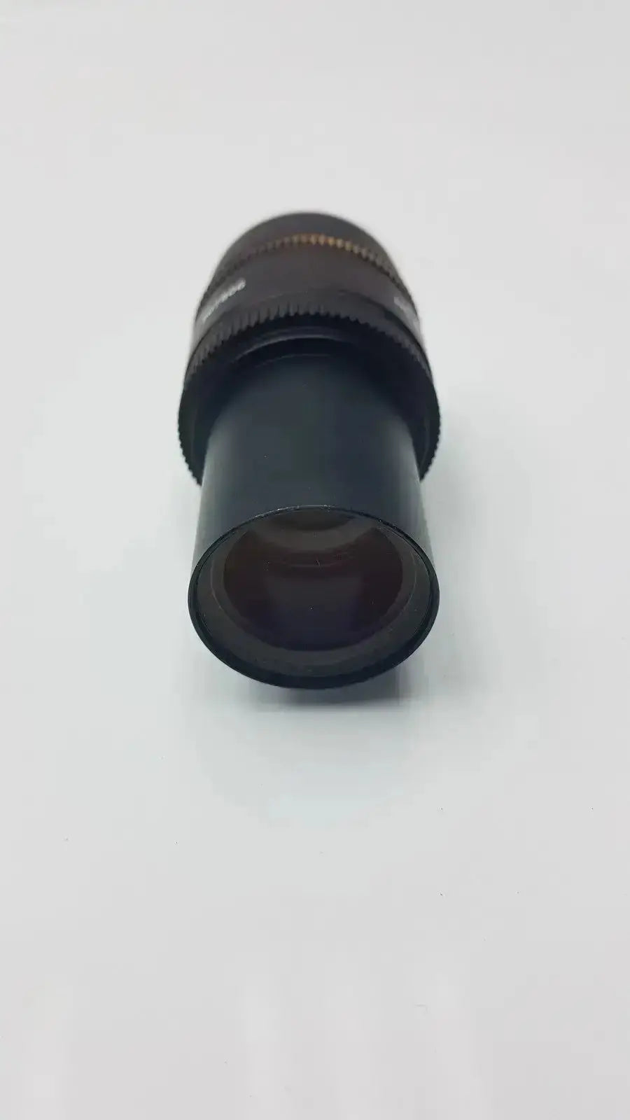 Black cylindrical leica hc plan microscope eyepiece with textured focus ring and metallic accents for hospital surplus use