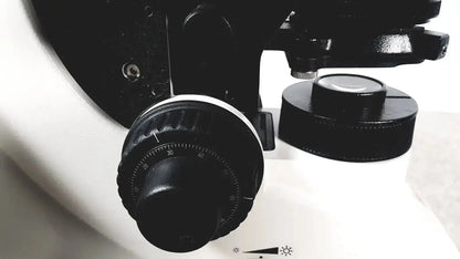 Black textured knob with circular degree scale on white surface of leica dm1000 pre owned medical equipment for sale