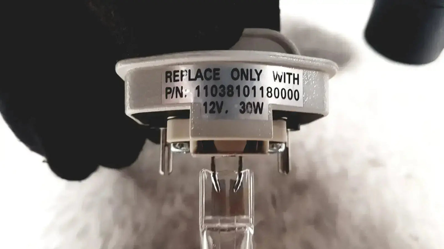 White circular halogen bulb base with part number and voltage rating for leica dm1000 used medical equipment for sale