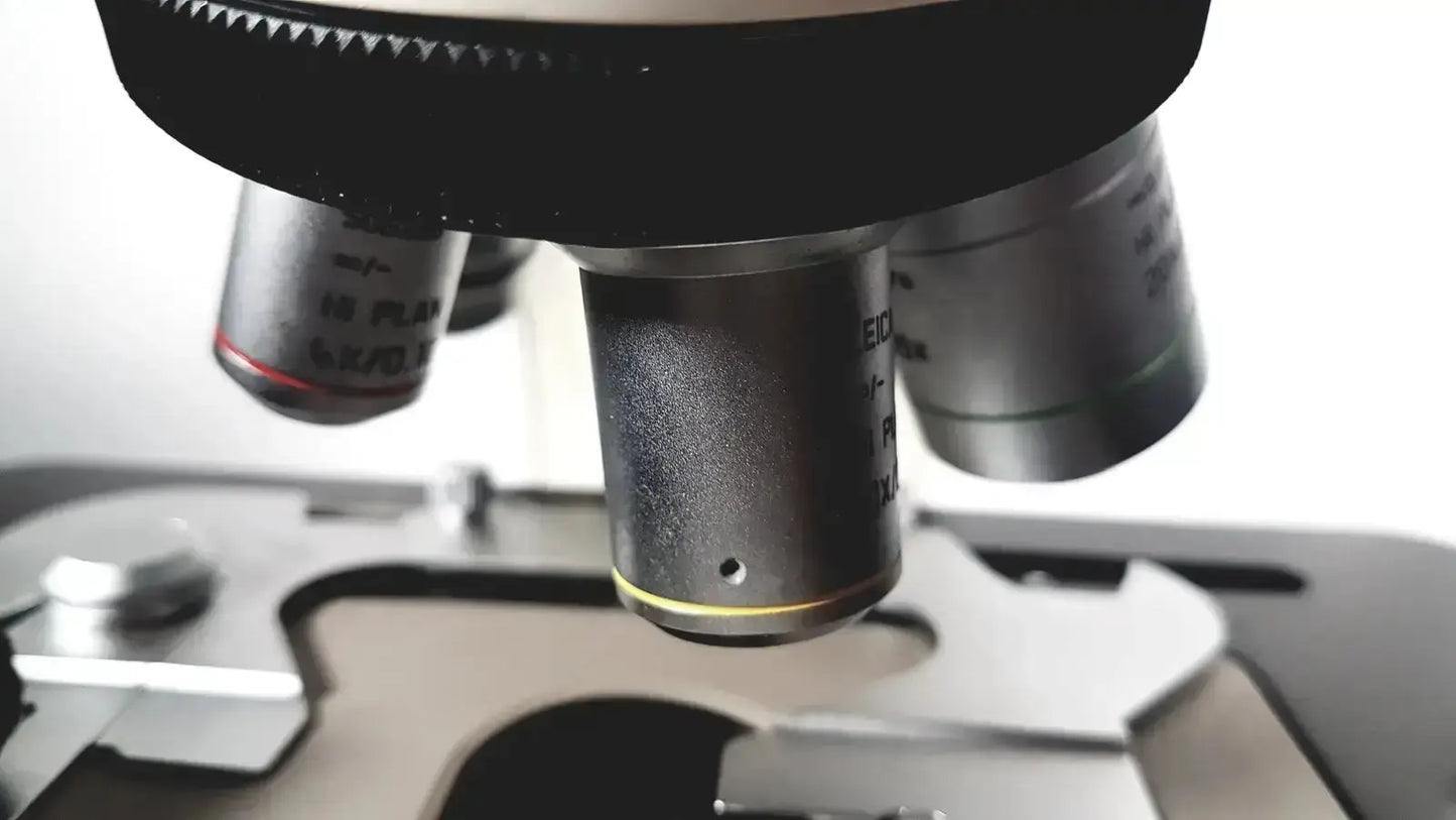 Black and silver microscope objective lenses with engraved markings for leica microscope model dm1000 heads