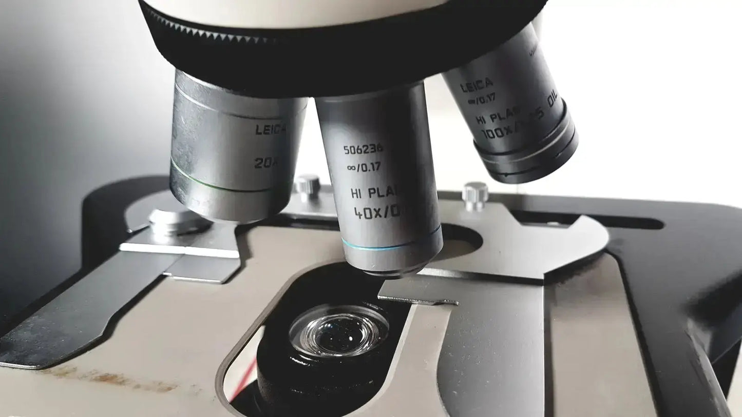 Leica dm1000 microscope with sleek metallic finish and multiple objective lenses for buy used medical equipment sale