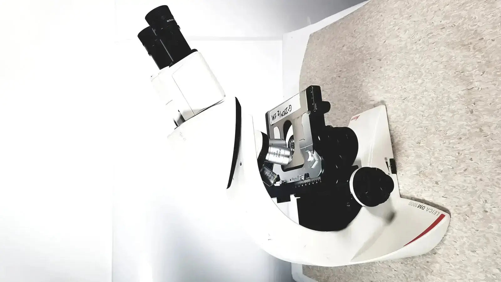 Leica dm1000 white and black compound microscope with silver metallic parts labeled willys buy used medical equipment for sale