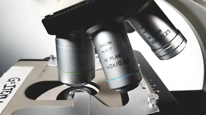 Silver metallic microscope objective lenses with engraved markings and blue accent line for leica dm1000 used medical equipment for sale