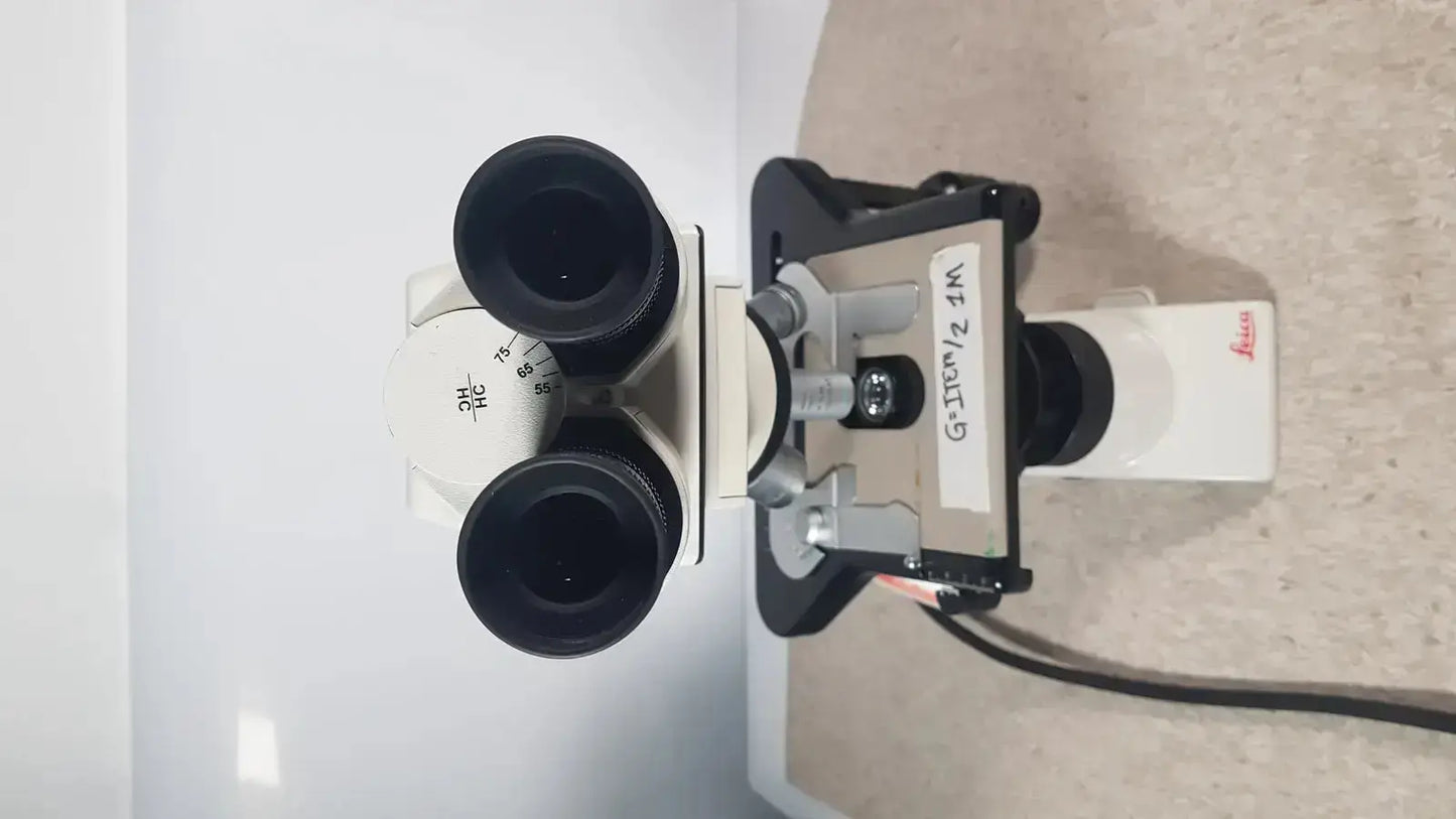 Leica dm1000 binocular microscope with black eyepieces and white body for pre owned medical equipment sale
