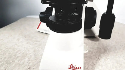 Leica dm1000 microscope with white base and black optical components ideal for buy used medical equipment needs