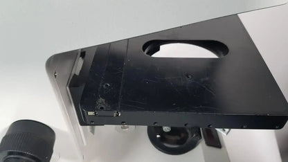 Black metal microscope stage with rectangular cutout and screws on leitz metallux 3 stereo zoom microscope