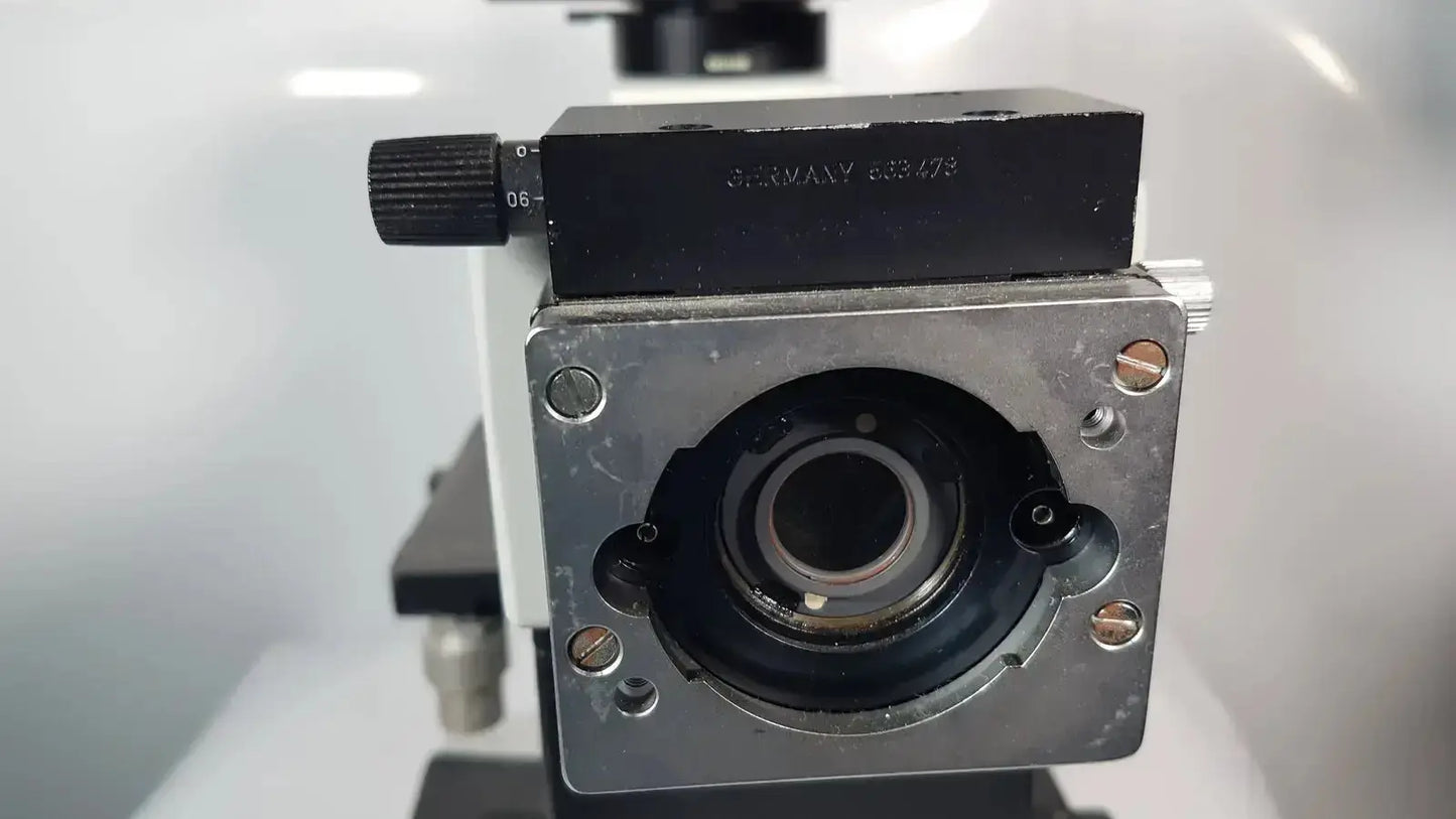 Black and silver engraved metal stage of leitz metallux 3 stereo zoom microscope highlighting precision design