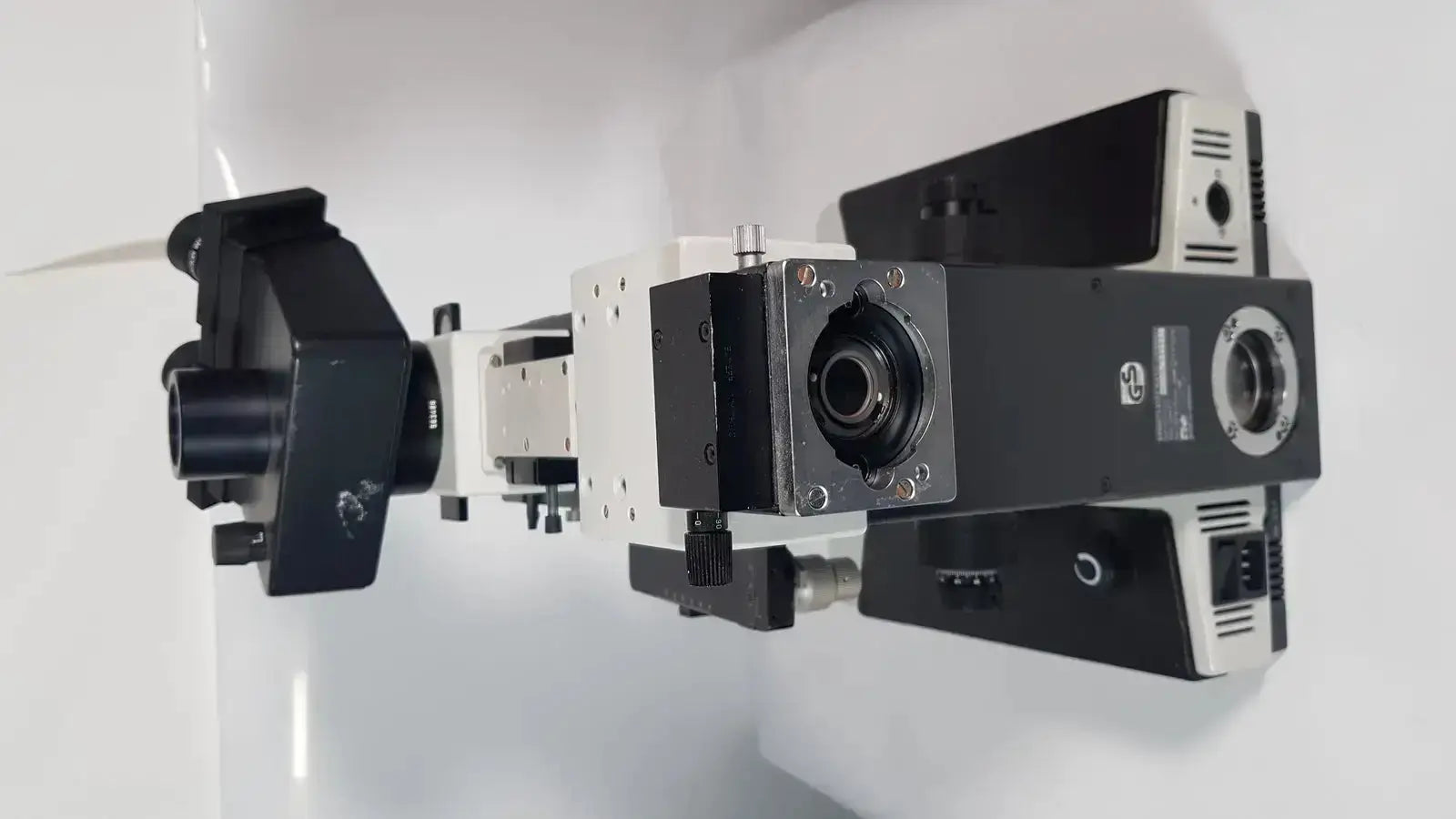 Black and white Leitz Metallux 3 stereo zoom microscope with robust modular design and multiple lenses and adjustment knobs