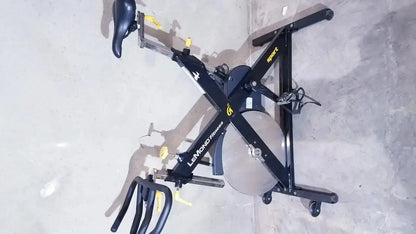 Black lemond fitness revmaster sport cycling bike with yellow accents and silver flywheel model 15700-3