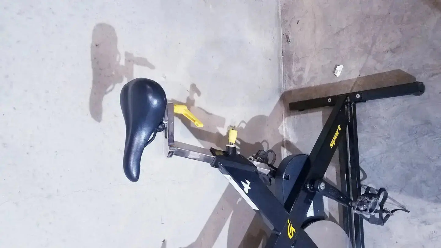 Black and yellow lemond fitness revmaster sport cycling bike with black seat and metal frame for indoor exercise