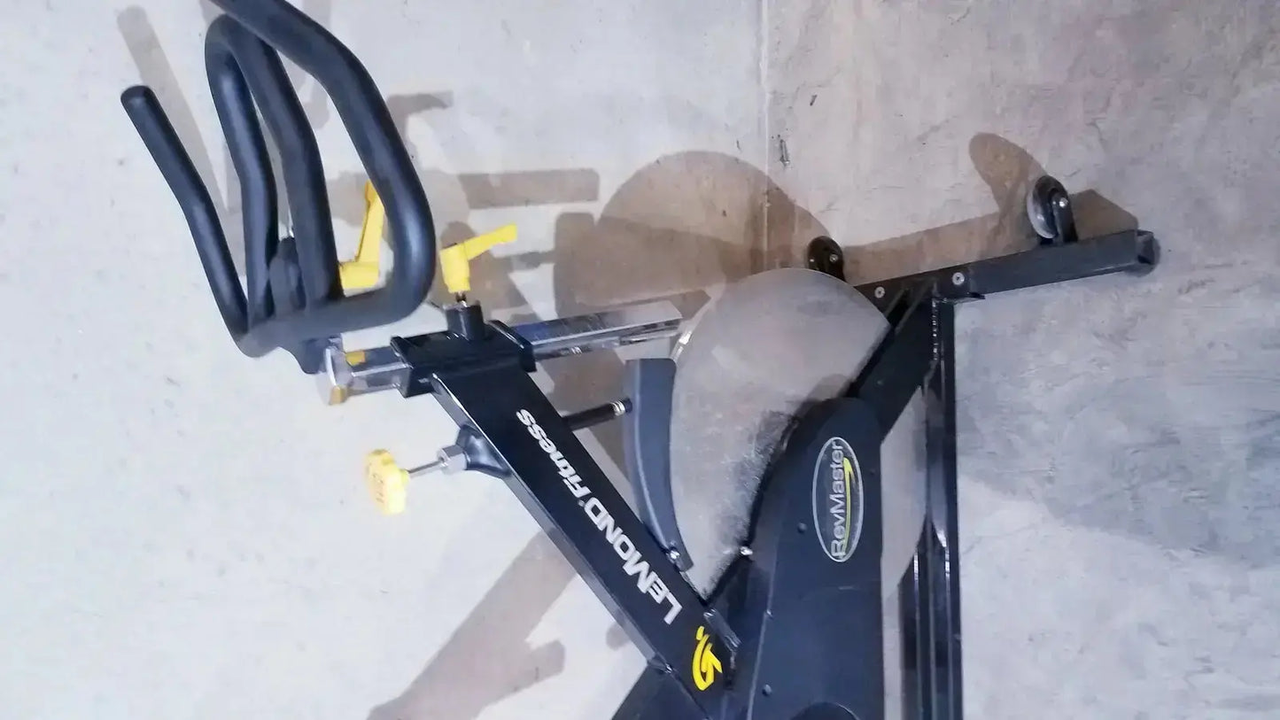 Black and yellow Lemond Fitness RevMaster sport cycling bike with sleek modern design for indoor exercise