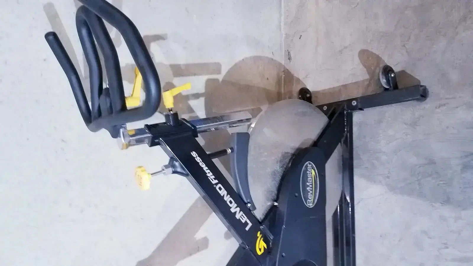 Black and yellow Lemond Fitness RevMaster sport cycling bike with sleek modern design for indoor exercise