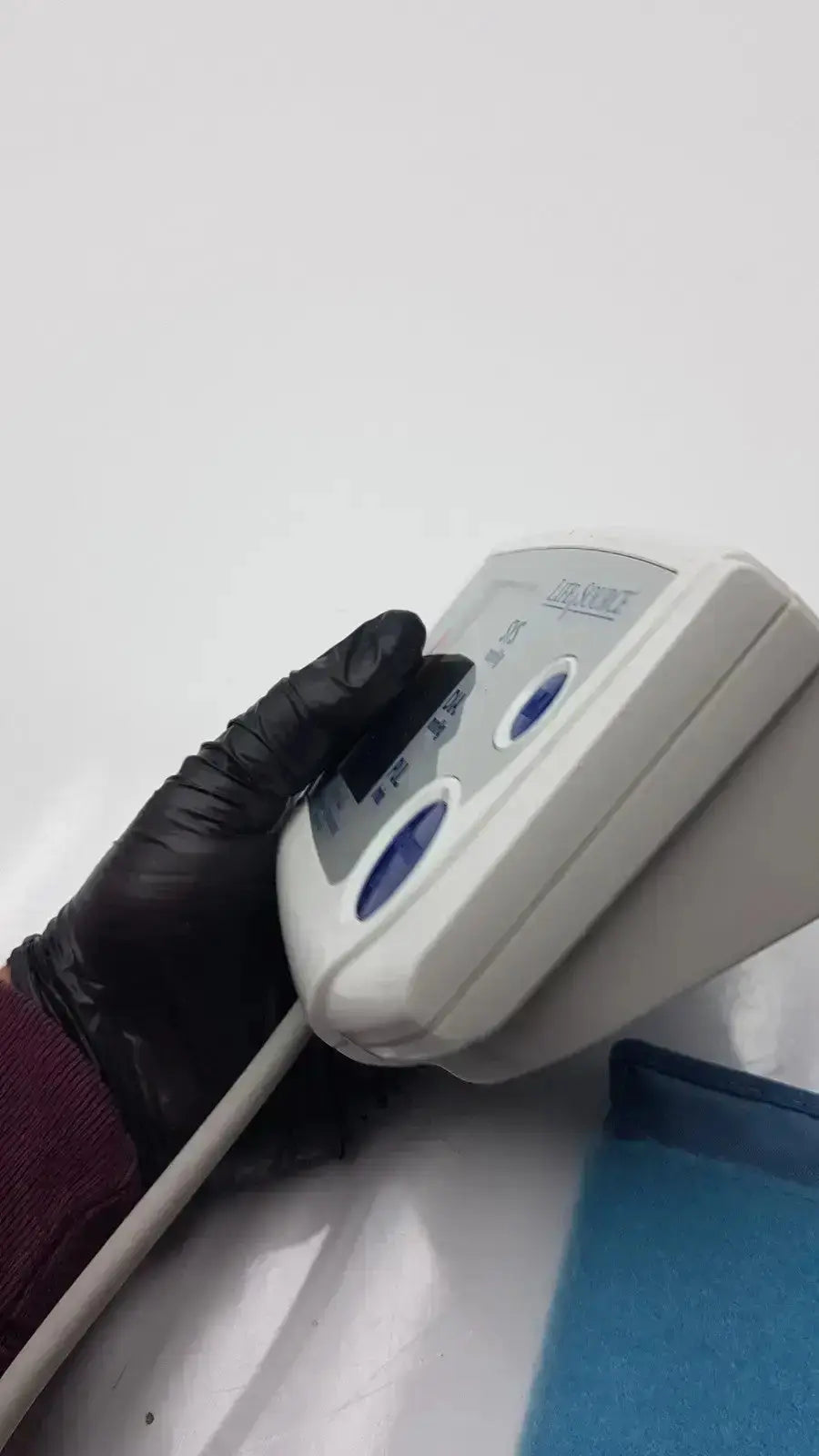 White plastic life source ua-767 plus digital blood pressure monitor with blue buttons and digital display by horiba