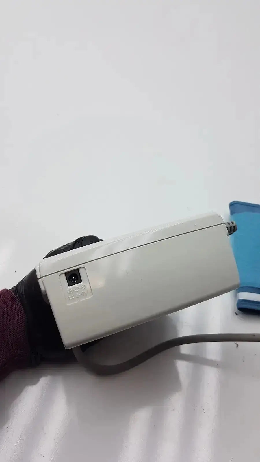 White plastic life source ua-767 plus digital blood pressure monitor with gray cord and black power button