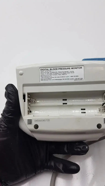 Life Source ua-767 plus digital blood pressure monitor in white plastic with blue accent and visible battery compartment back view