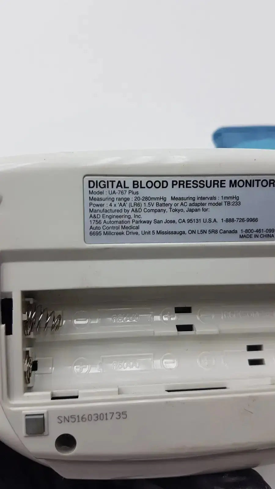 White plastic digital blood pressure monitor life source ua-767 plus with label showing model and specifications information