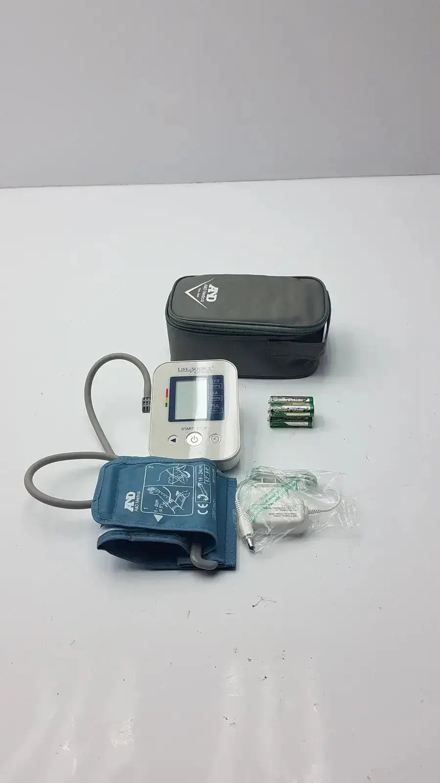 Silver LifeSource A&D Medical digital blood pressure monitor with blue inflatable cuff gray tubing and black carrying case