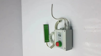 Gray industrial control box with red emergency stop and green push-button coiled to green handset linak cbj2005hd112xx4