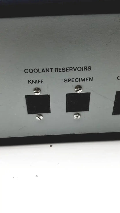 Gray metal panel with black knife and specimen ports on the back of lkb cryokit control unit cat no 14803 serial no 288