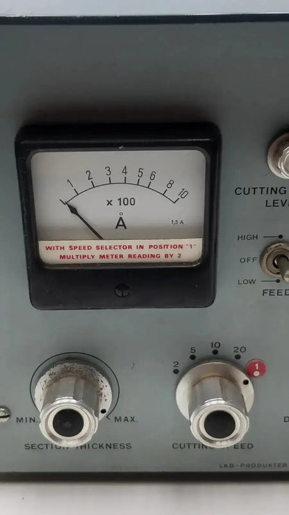 Gray metal panel of lkb ultrotome control unit type 4802A with black analog ammeter and silver rotary knobs for section thickness and cutting speed