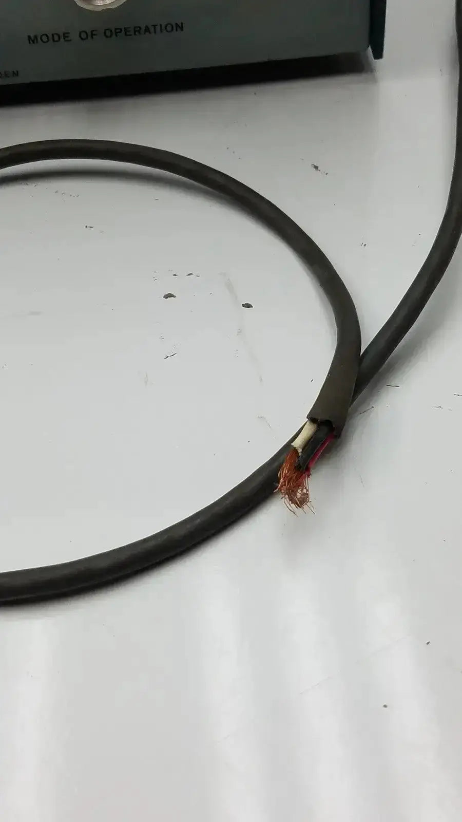 Black insulated cable with exposed copper wires at the back of lkb ultrotome control unit type 4802a control unit