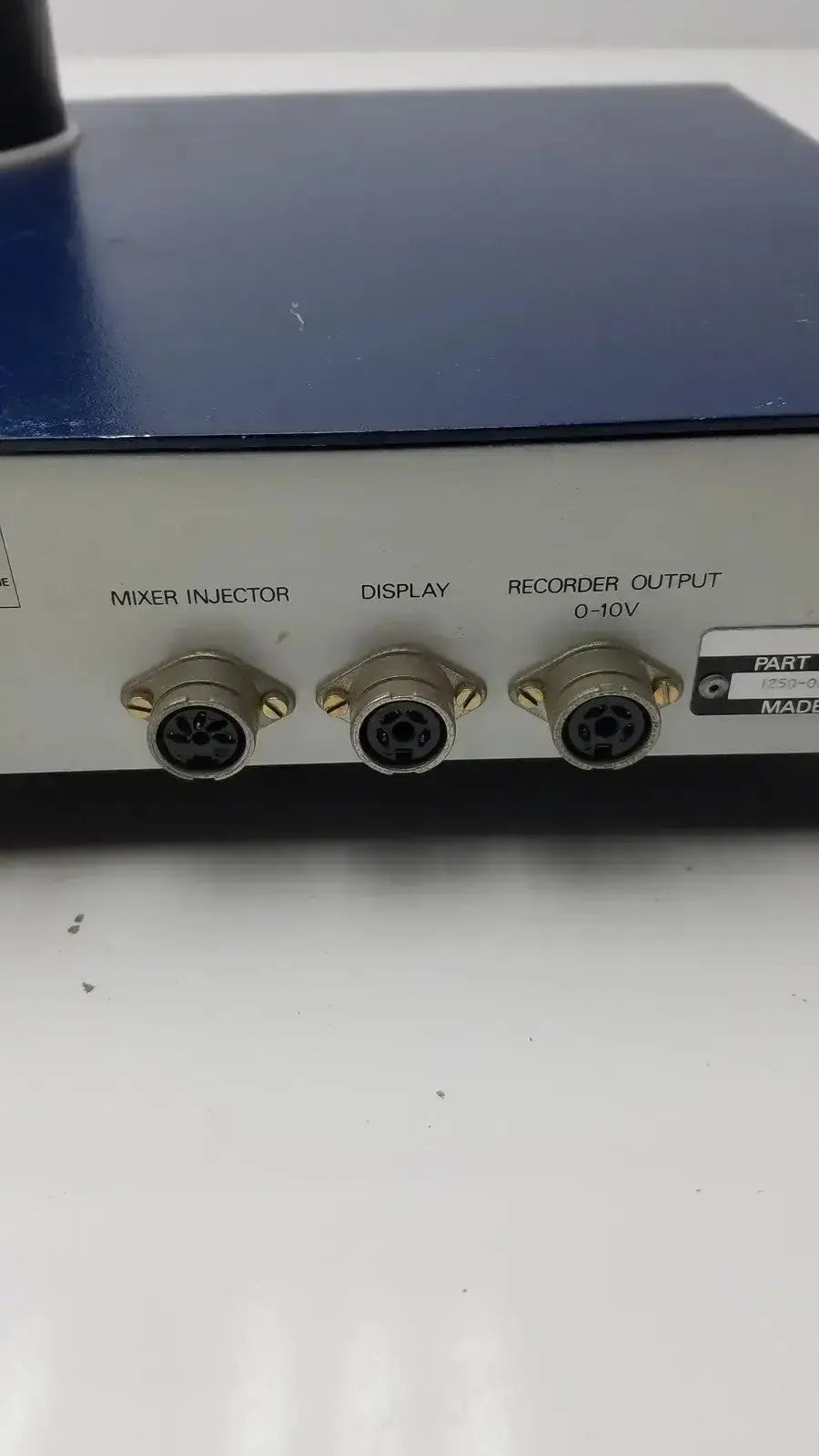 Backside of a blue and white lkb wallac 1250 luminometer with three circular connectors for biomedical technicians and hospital surplus use