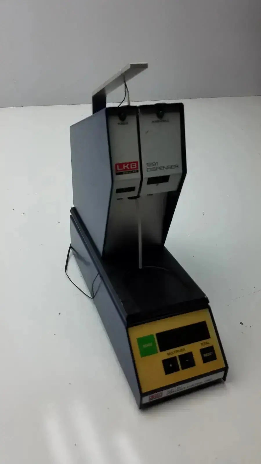Lkb wallac 1291 reagent dispenser in black and yellow with digital display panel for in vitro diagnostic use