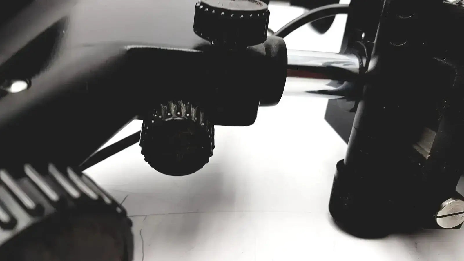 Black textured adjustment knobs on the back of lombart instrument keratometer model 12515 lens mount