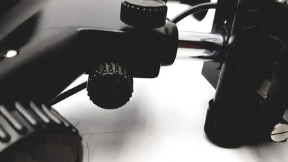 Black textured adjustment knobs on the back of lombart instrument keratometer model 12515 lens mount