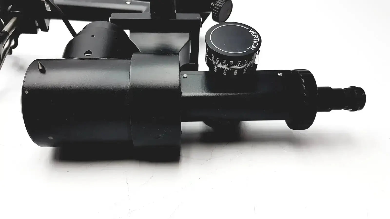Black metal telescope mount with circular adjustment dial marked merical and engraved scale on lombart instrument keratometer model 12515